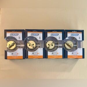 Four Schlage Bright Brass Deadbolt. Never been used & still in original box.